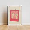 A framed poster with a minimalistic design featuring two hands making a pinky promise, set against a beige background with pink borders. The text "always & forever" is written at the bottom. The poster is placed on a wooden floor, leaning against a white wall.